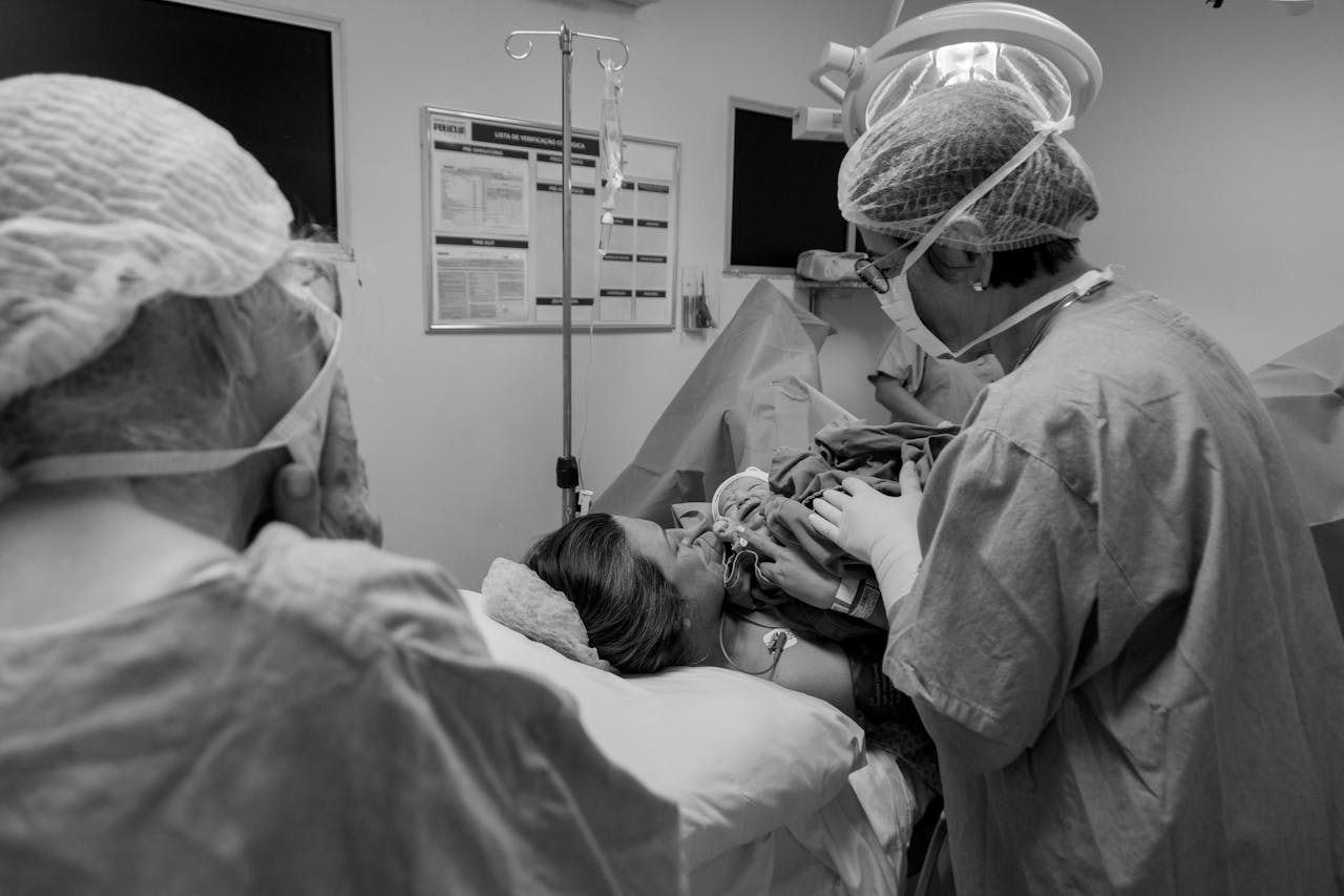 Grayscale Photo of Woman Lying on Hospital Bed